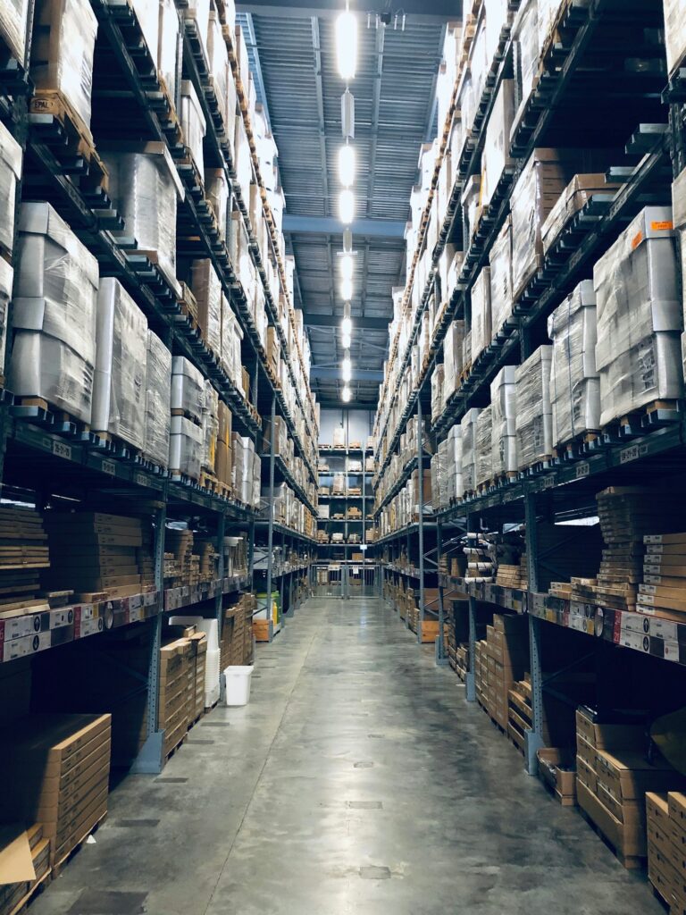 Warehouse worker moving inventory (illustrative stock photo)